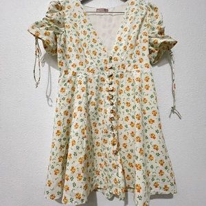 White puff sleeve dress with clementine floral pattern and pockets